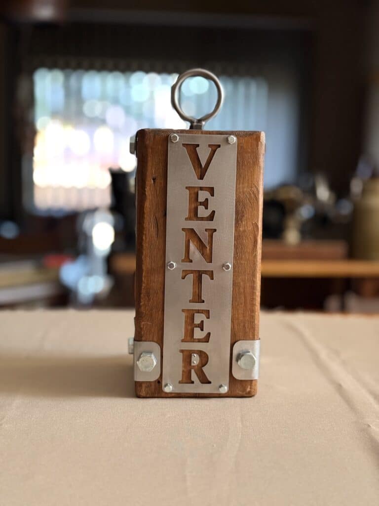 Personalised wooden and stainless steel wedding doorstop with Venter surname